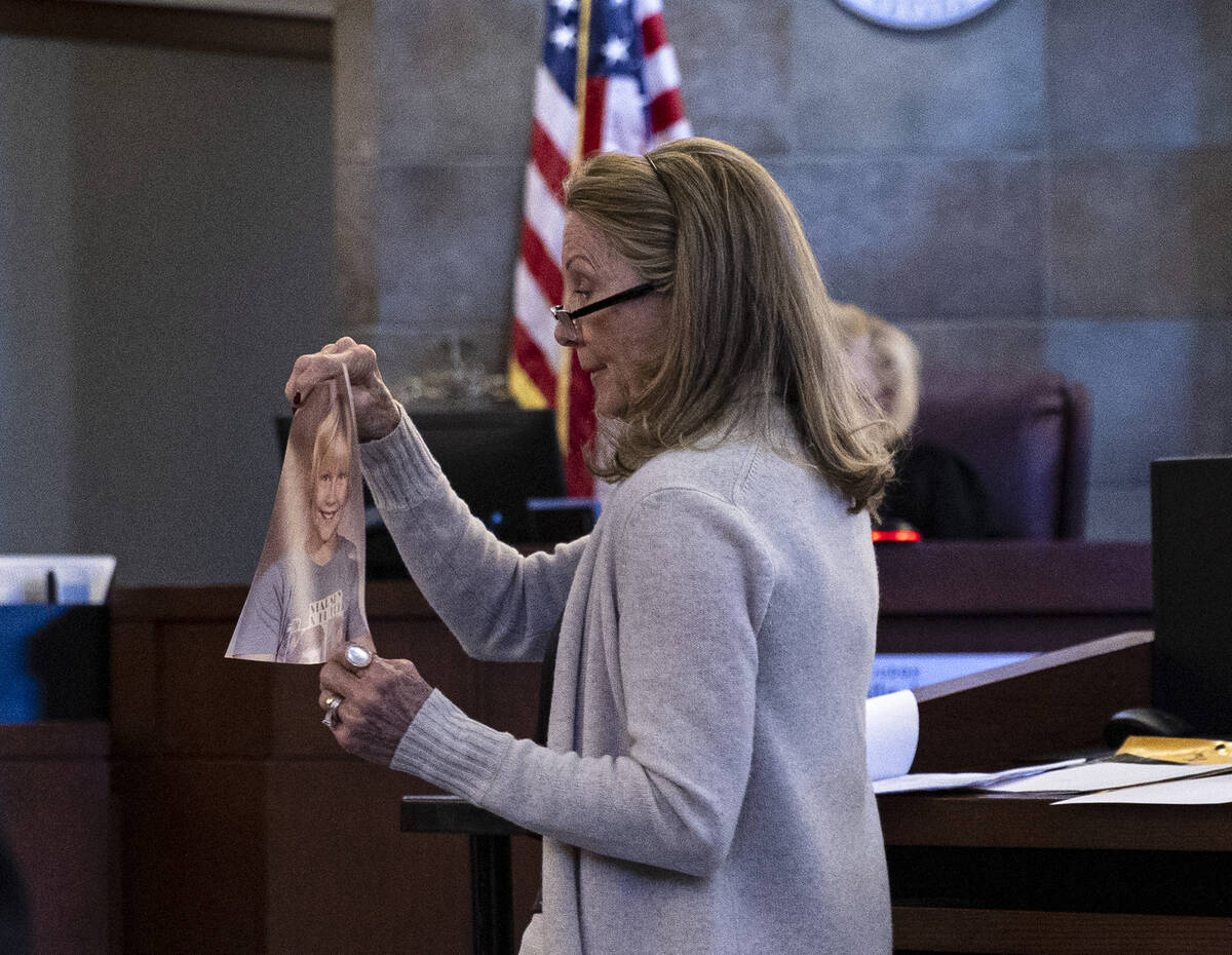 Avis Winters, the mother of attorney Susan Winters, displays her daughter’s photograph as she ...