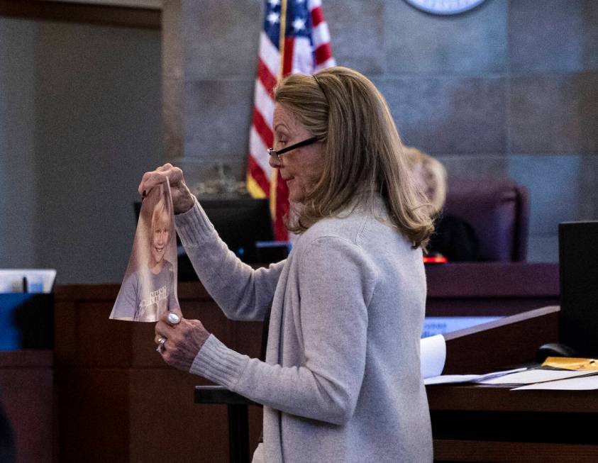Avis Winters, the mother of attorney Susan Winters, displays her daughter’s photograph as she ...