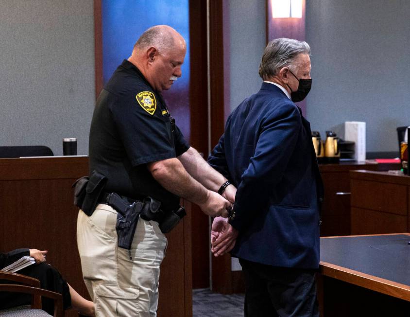 A court officer places handcuffs on Gregory "Brent" Dennis after Dennis’ sentencing at the Re ...