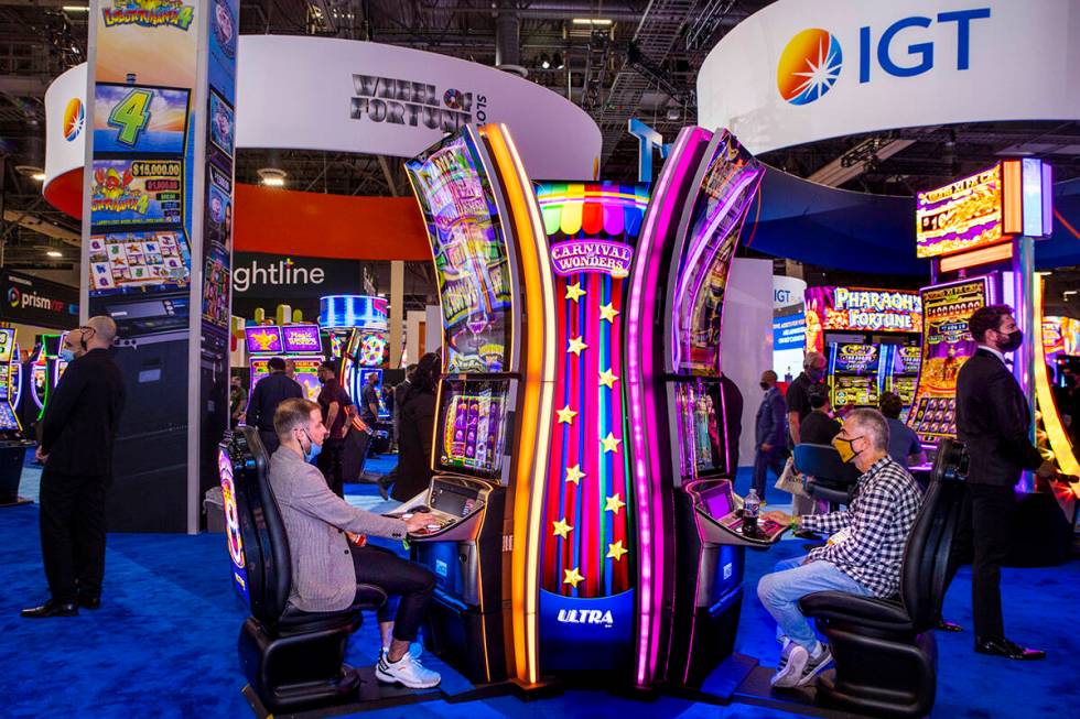 Attendees play the Carnival of Wonders machines in the IGT display space during day 2 of the Gl ...