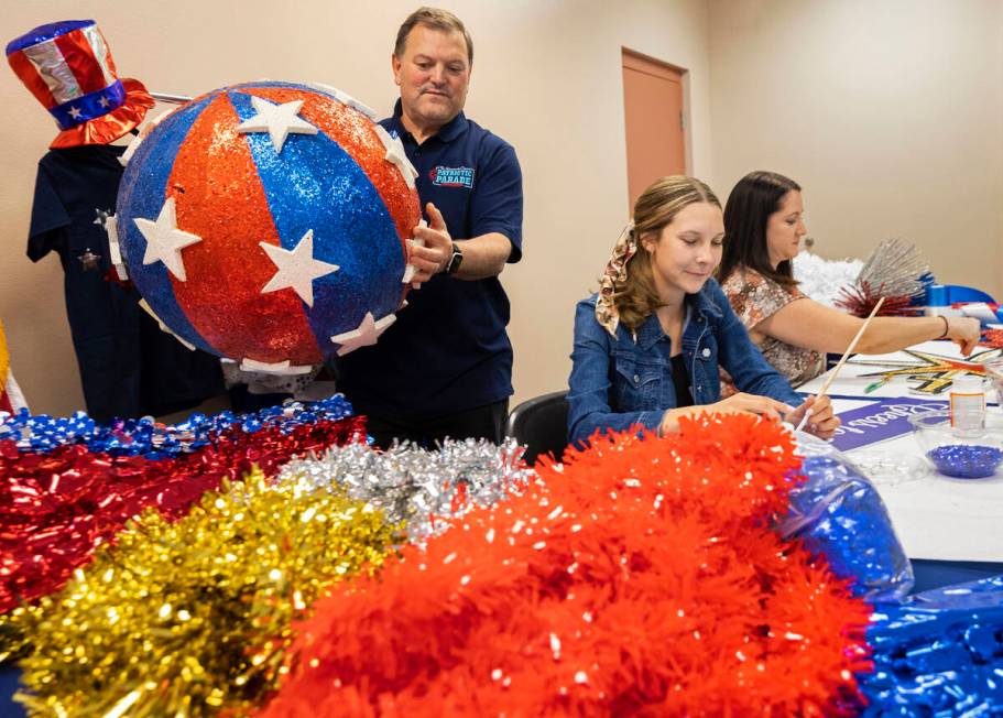 Tommy Porrello, left, Danielle Cox and Shannon Cavasar prepare for the July Fourth parade at Tr ...