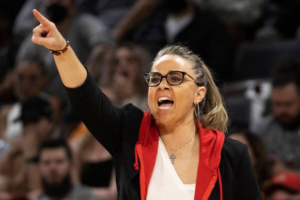 Aces head coach Becky Hammon coaches up her team in the second half of a WNBA basketball game a ...