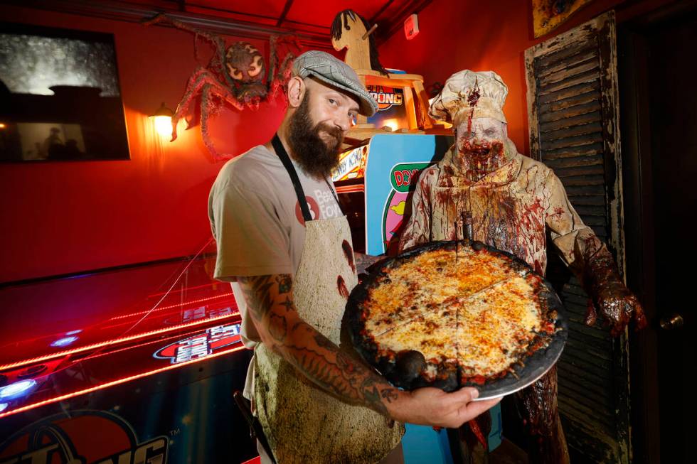 Sliced Pizza co-owner Cash Sakoulas shows a Murder Pie at his shop, Sunday, May 8, 2022, in Las ...