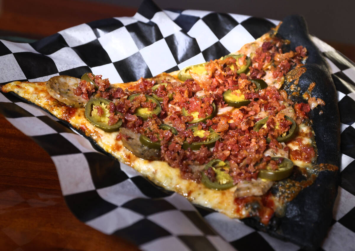 A slice of Murder Pie with toppings is seen at Sliced Pizza, Sunday, May 8, 2022, in Las Vegas. ...