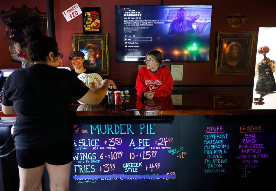 Sliced Pizza co-owner Nina Sakoulas, center, talks with her customer at her shop, Sunday, May 8 ...