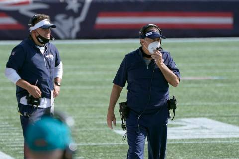 New England Patriots offensive coordinator Josh McDaniel, left, head coach Bill Belichick watch ...