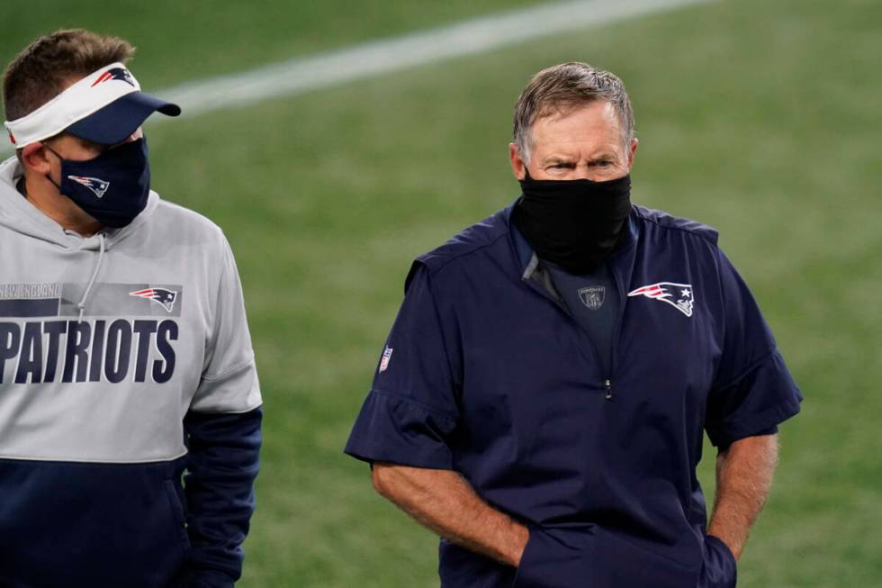 New England Patriots offensive coordinator Josh McDaniels and head coach Bill Belichick leave t ...