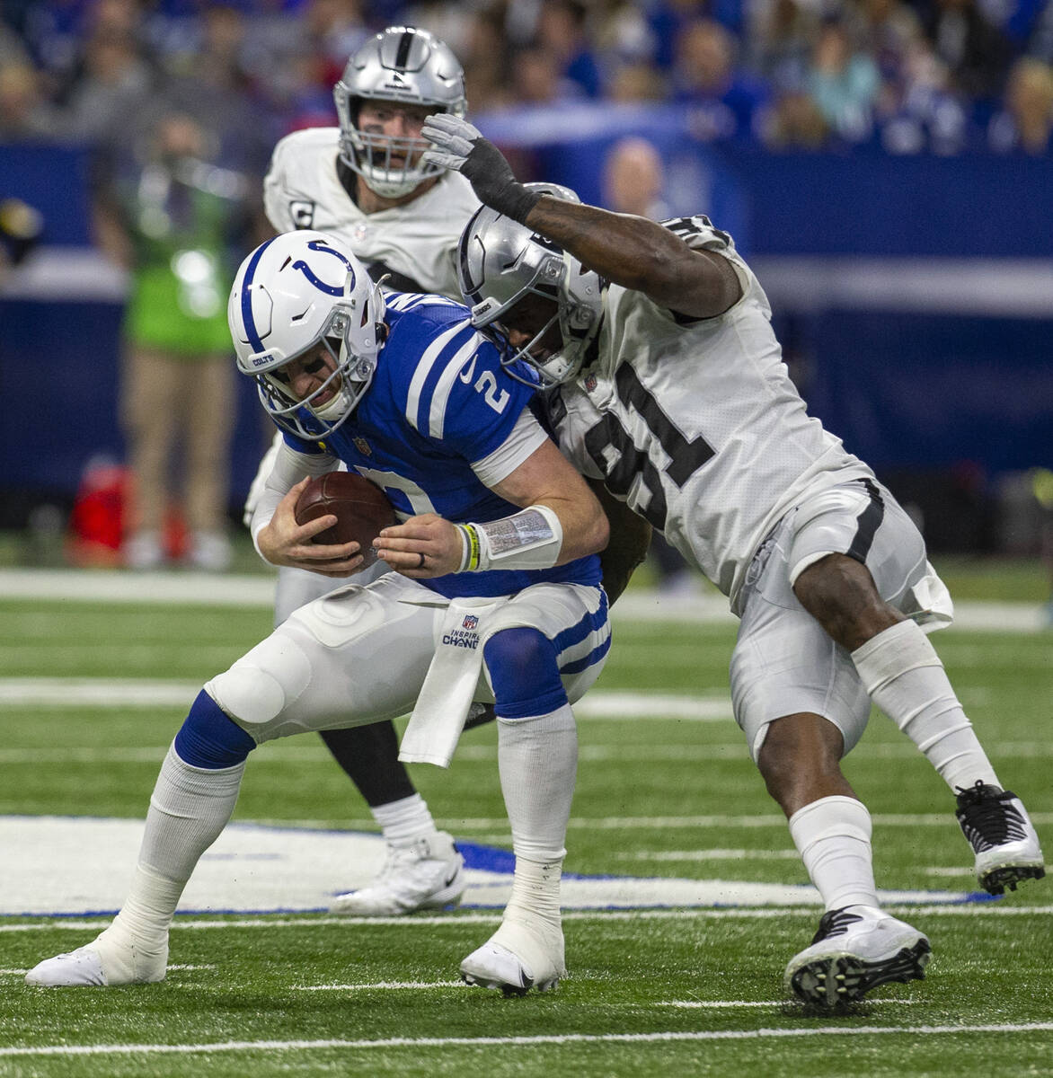 Raiders defensive end Yannick Ngakoue (91) sacks Indianapolis Colts quarterback Carson Wentz (2 ...