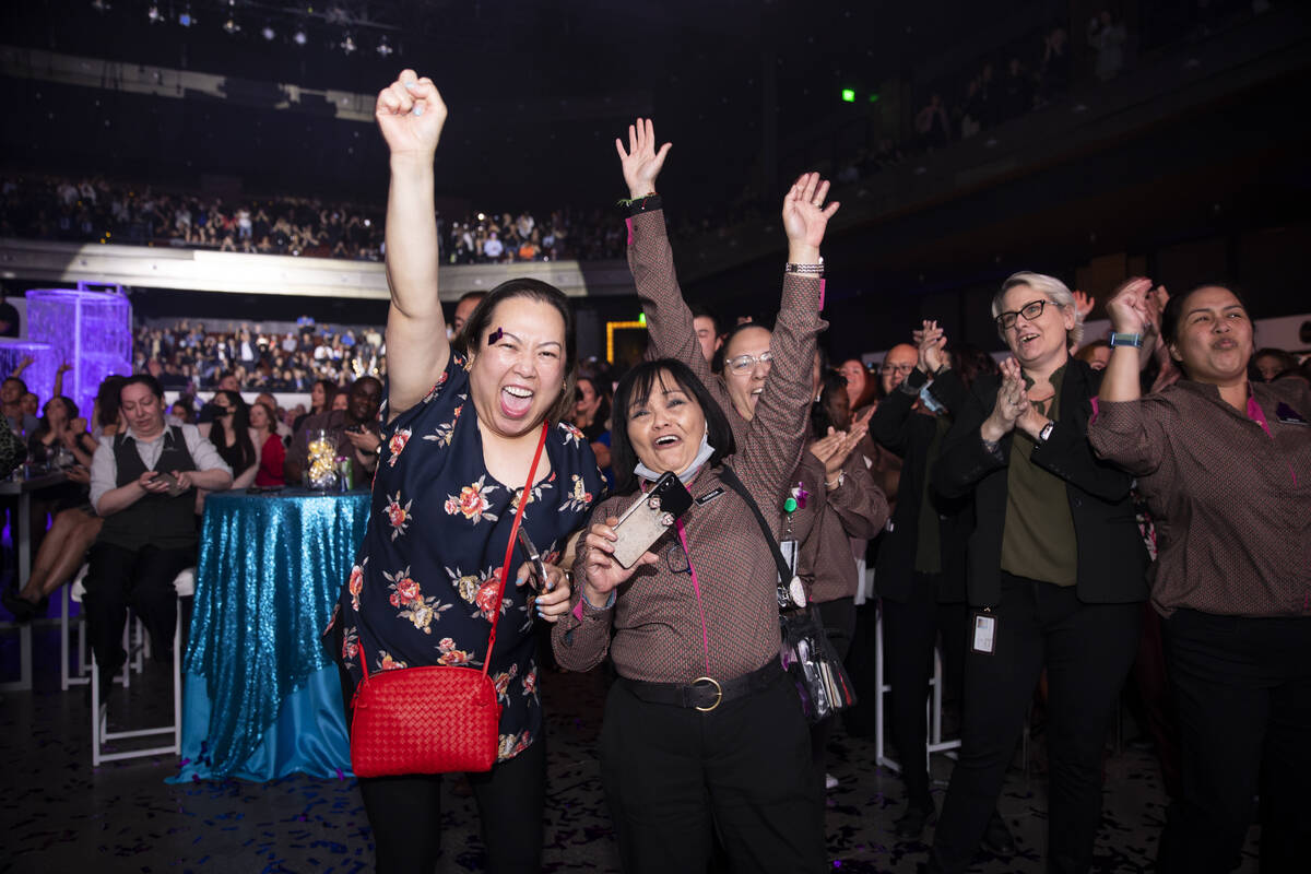 Cosmopolitan of Las Vegas employees celebrate after they were awarded a $5000 bonus during an e ...