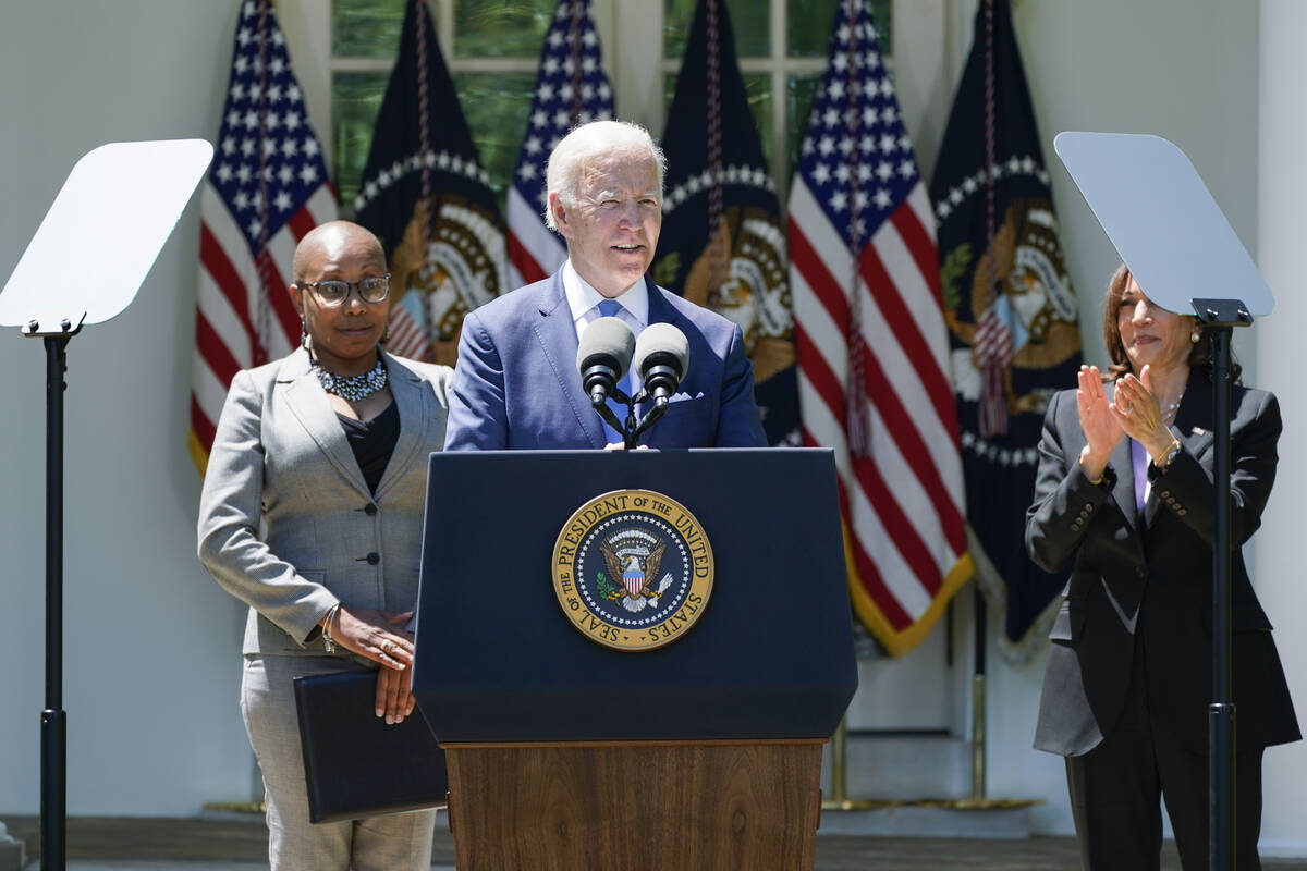 Vice President Kamala Harris applauds as President Joe Biden speaks at an event on lowering the ...