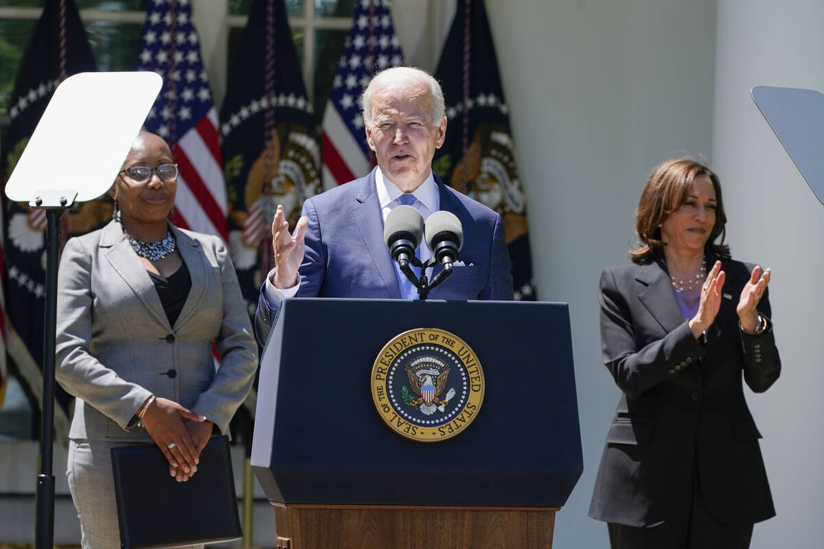 Vice President Kamala Harris applauds as President Joe Biden speaks at an event on lowering the ...