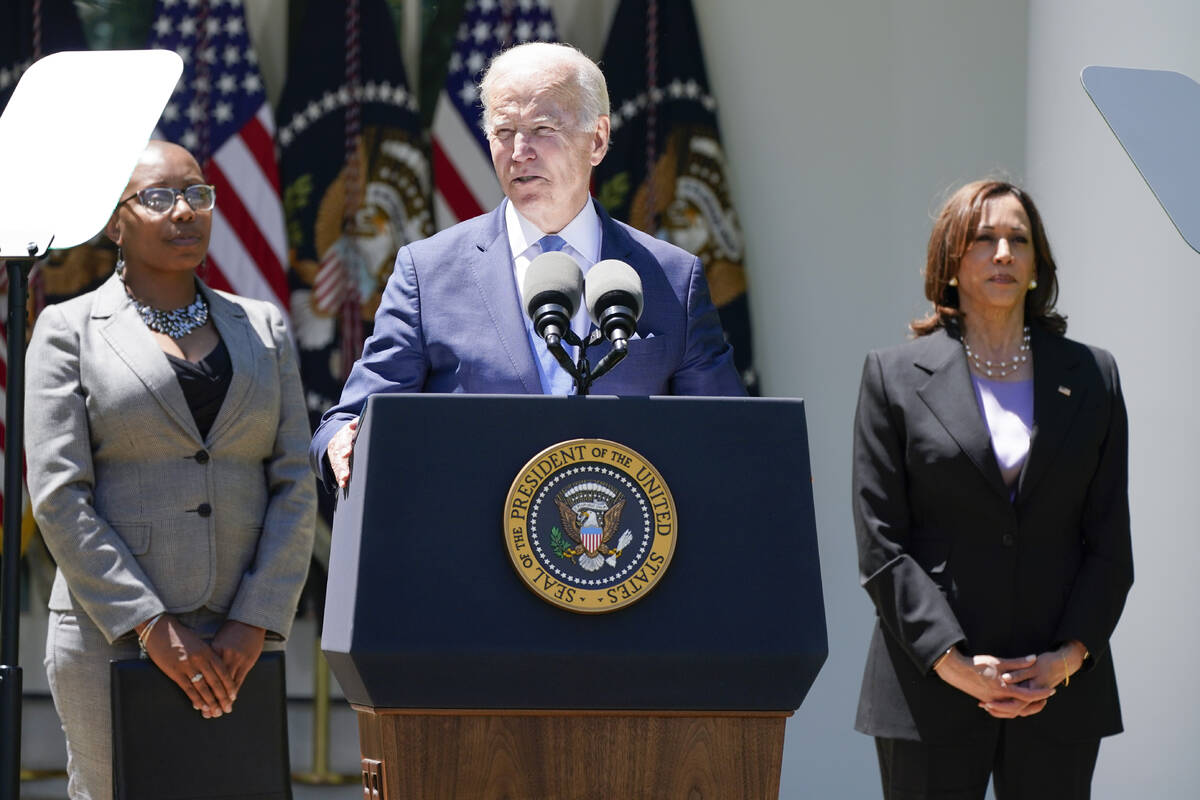 Vice President Kamala Harris, right, listens as President Joe Biden speaks at an event on lower ...