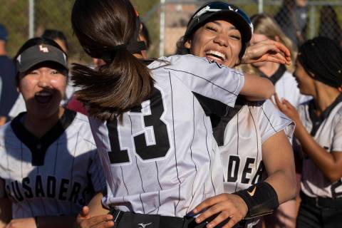 Faith Lutheran’s Sydney Schafer (9) celebrates with Marin Young (13) after the Crusaders ...