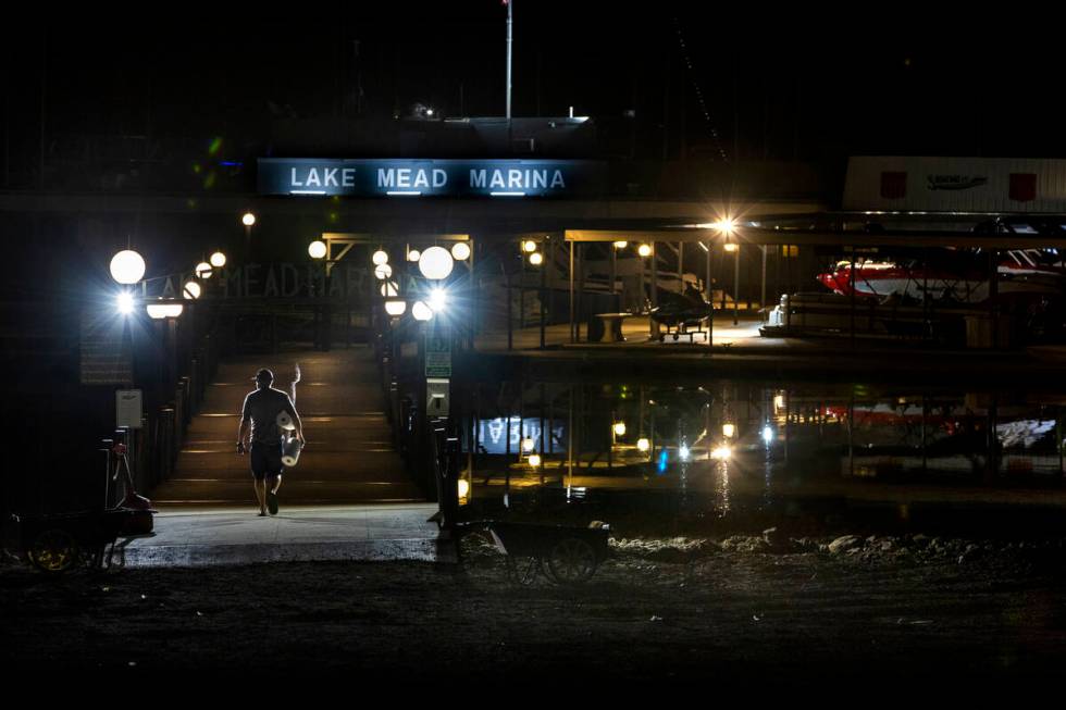 A visitor walks onto the dock at the Lake Mead Marina as the waterline continues to recede alon ...