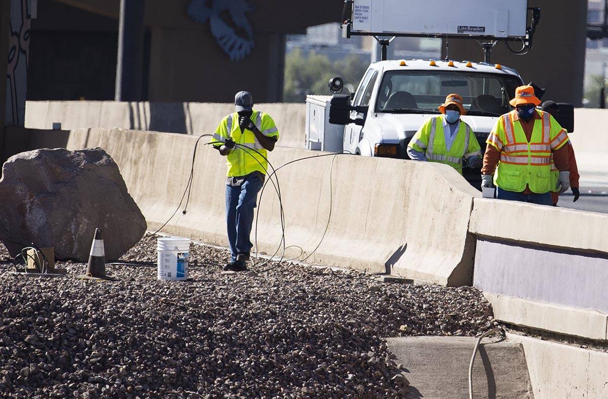NDOT workers replace copper wire after Spaghetti Bowl lights were knocked out by copper wire th ...