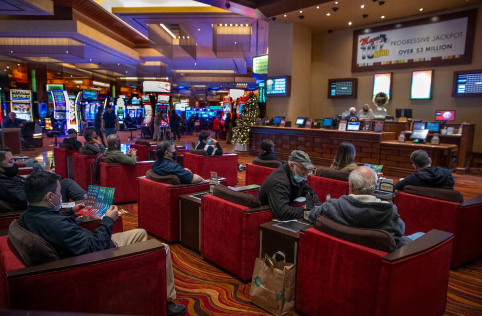 Guests play Keno on the gaming floor at Red Rock Casino on Tuesday, Dec. 26, 2021, in Las Vegas ...
