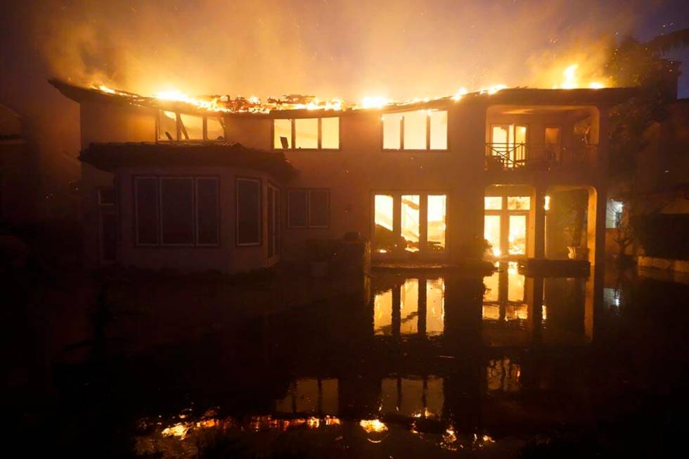 A structure burns during a wildfire Wednesday, May 11, 2022, in Laguna Niguel, Calif. (AP Photo ...