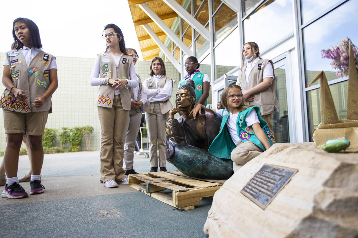 Girl Scouts from different troops gather around the statue “In Grace” which had b ...
