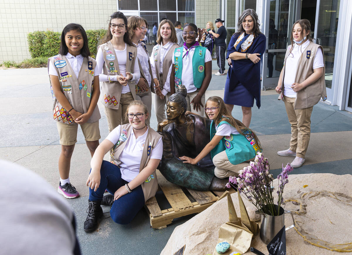 Girl Scouts from different troops gather around "In Grace,” a statue that had been ...