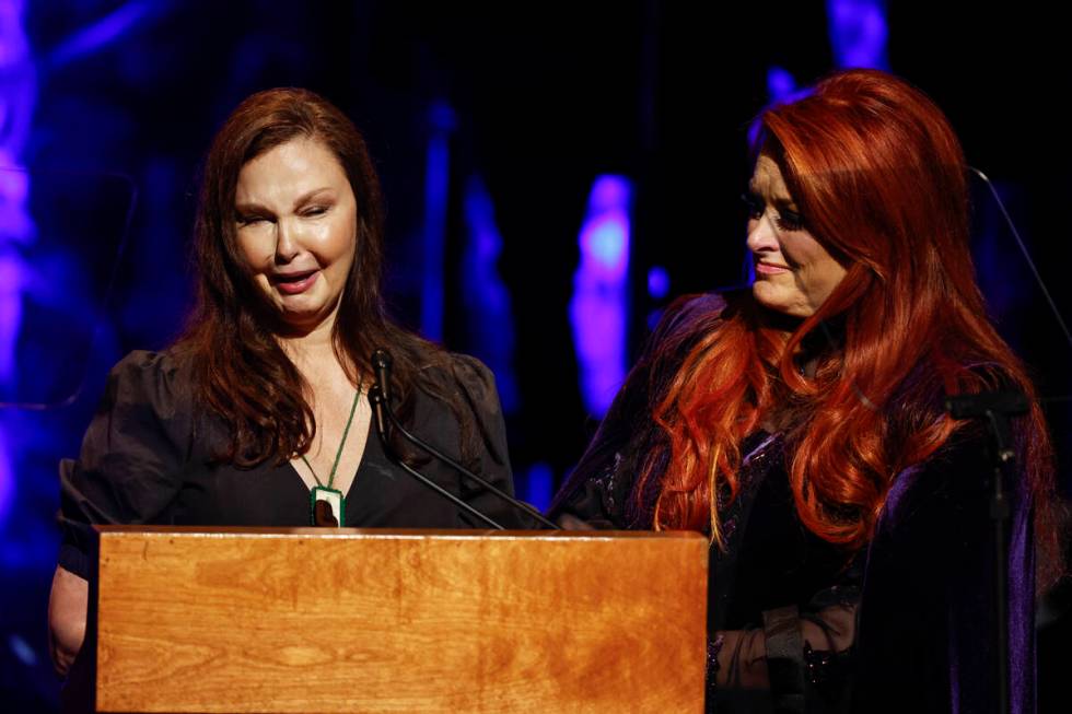 Ashley Judd, left, cries as she speaks while sister Wynonna Judd listens during the Country Mus ...