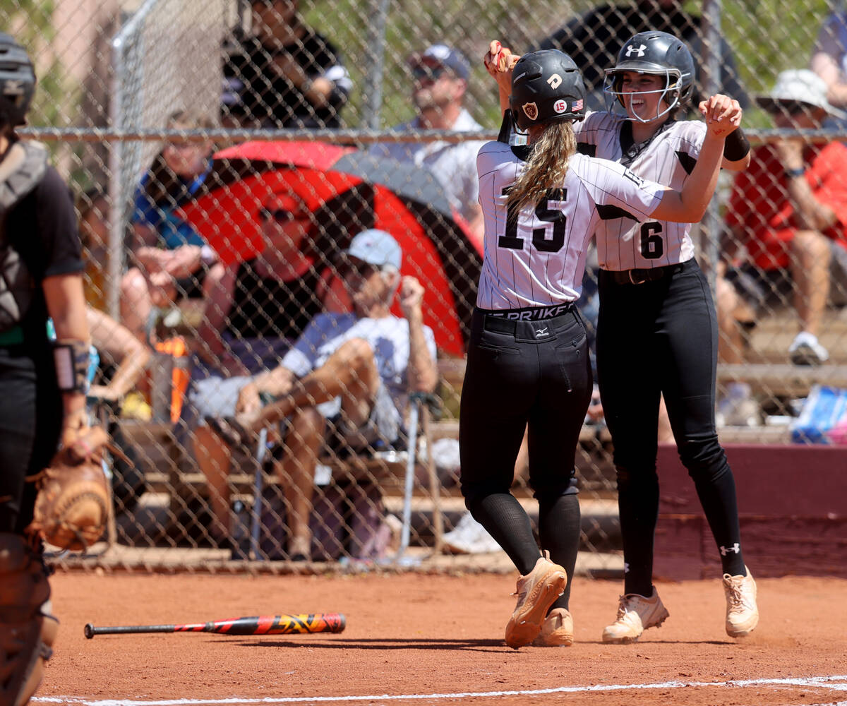 Faith Lutheran’s Savannah Moore (15) and Emily Sholeff (6) celebrate a run in the 1st in ...