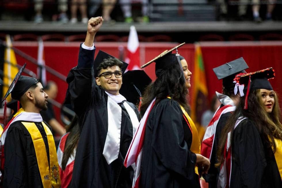 Postgraduate German Martinez raises his fist during an UNLV commencement ceremony at the Thomas ...