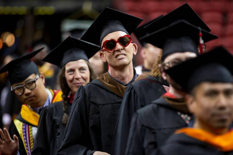 Postgraduate John McVay, center, participates during an UNLV commencement ceremony at the Thoma ...