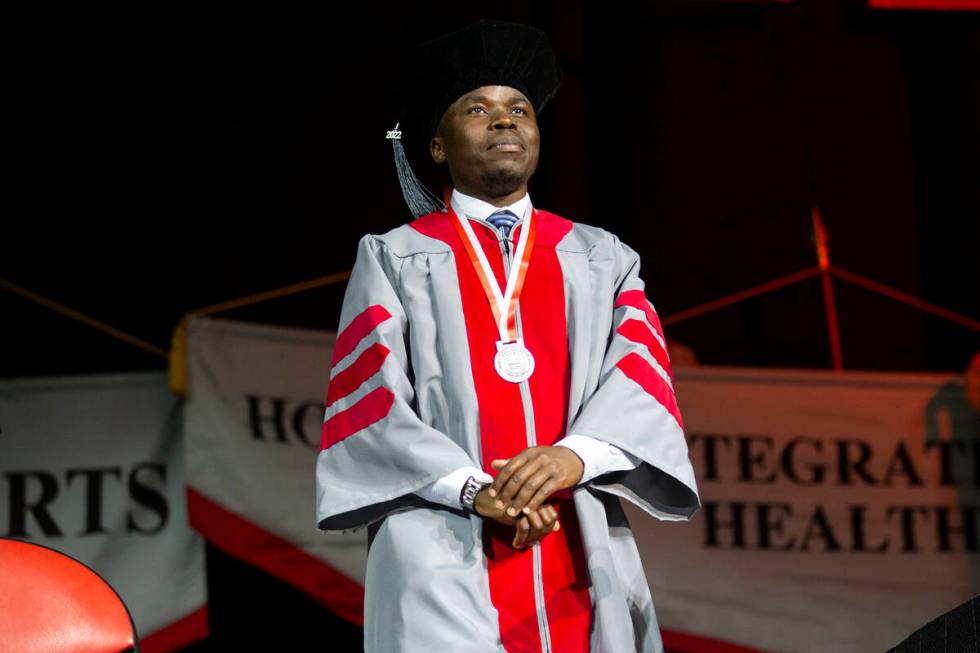 Postgraduate George William Kajjumba is recognized during an UNLV commencement ceremony at the ...