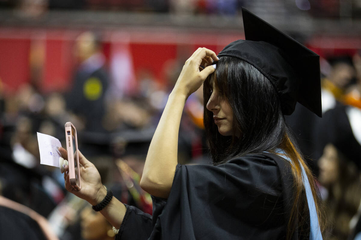Postgraduate Shehd Azzeh gets ready to walk the stage during an UNLV commencement ceremony at t ...