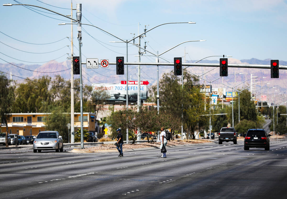 Pedestrians cross Sahara Avenue at Paseo Del Prado in Las Vegas, Sunday, May 15, 2022. Safety u ...