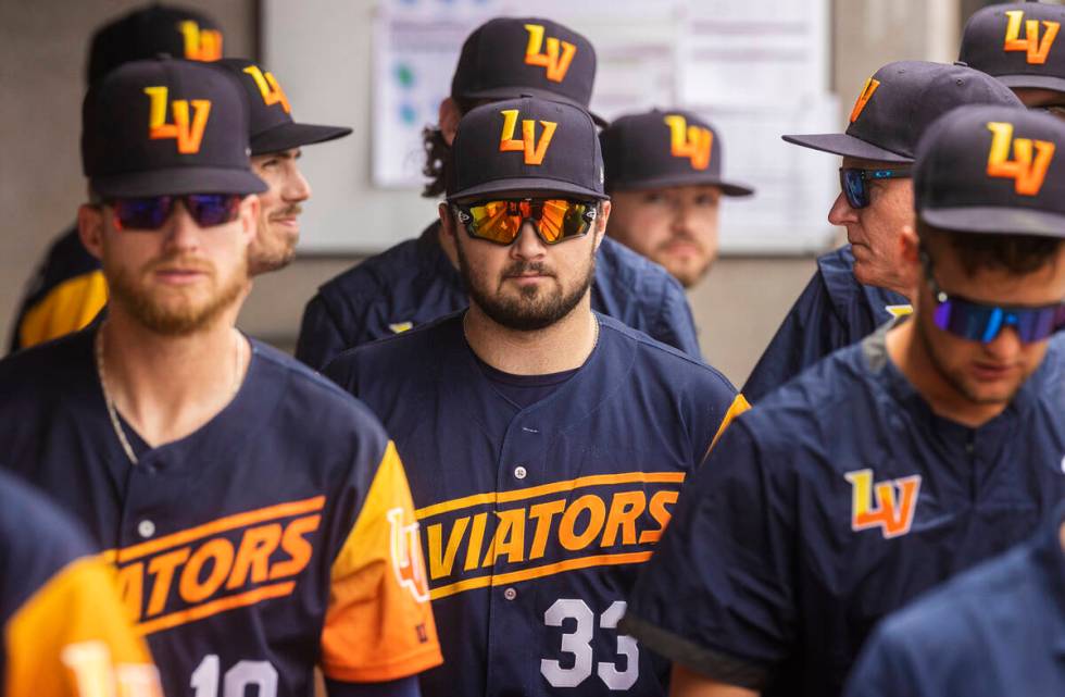 Aviators catcher Shea Langeliers (33) stands in the dugout with teammates during a minor league ...