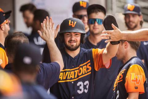 Aviators catcher Shea Langeliers (33) celebrates with teammates after scoring during a minor le ...