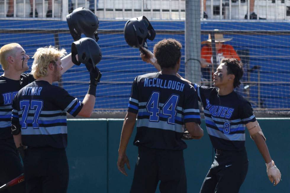 Basic Tate Southisene (8) is congratulated by teammates, Mason Neville, from left, Chase Ditmar ...