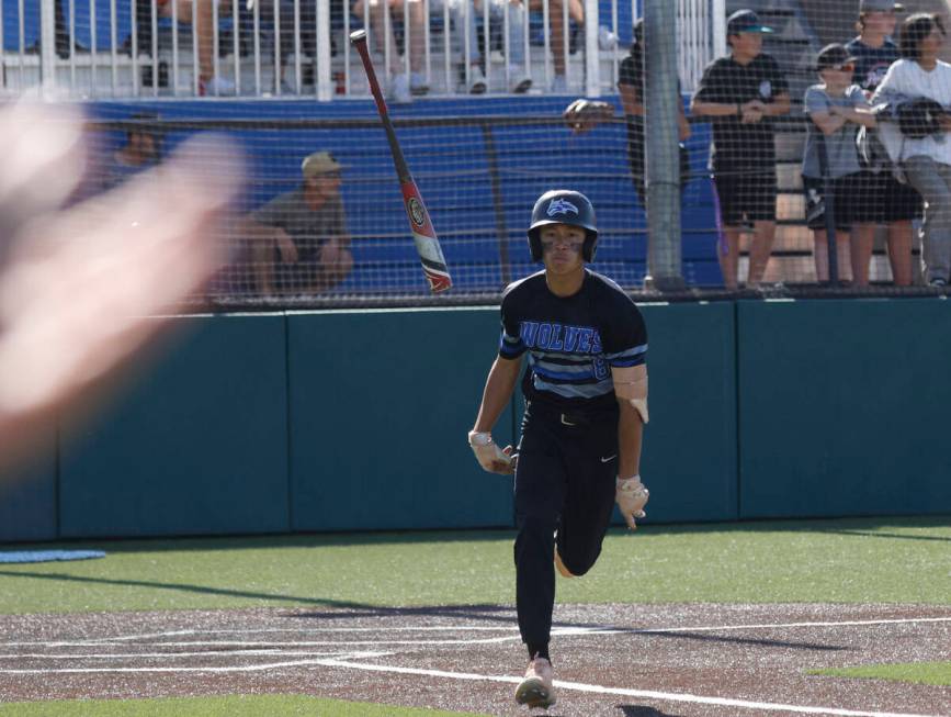 Basic's Tate Southisene flips the bat after he hits a ball during the fifth inning of a basebal ...