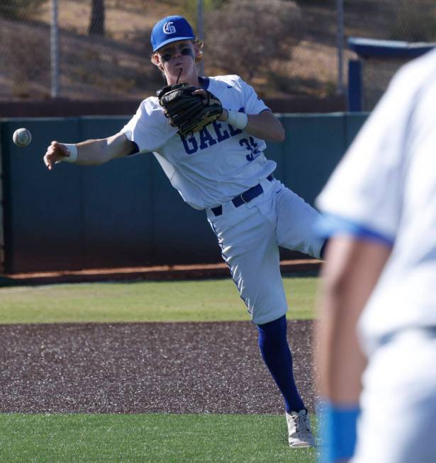 Bishop Gorman's Payton Smith throws a ball hit by Basic's Colin Hushaw to the first base during ...