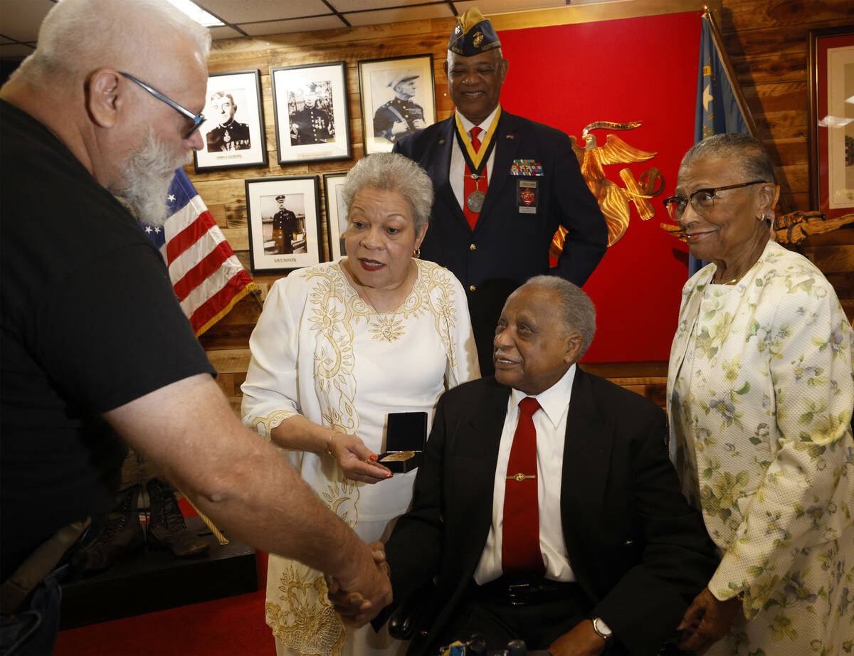 Henry Franklin Jackson, 96, of Las Vegas, center, is congratulated by US Army paratrooper Spc. ...