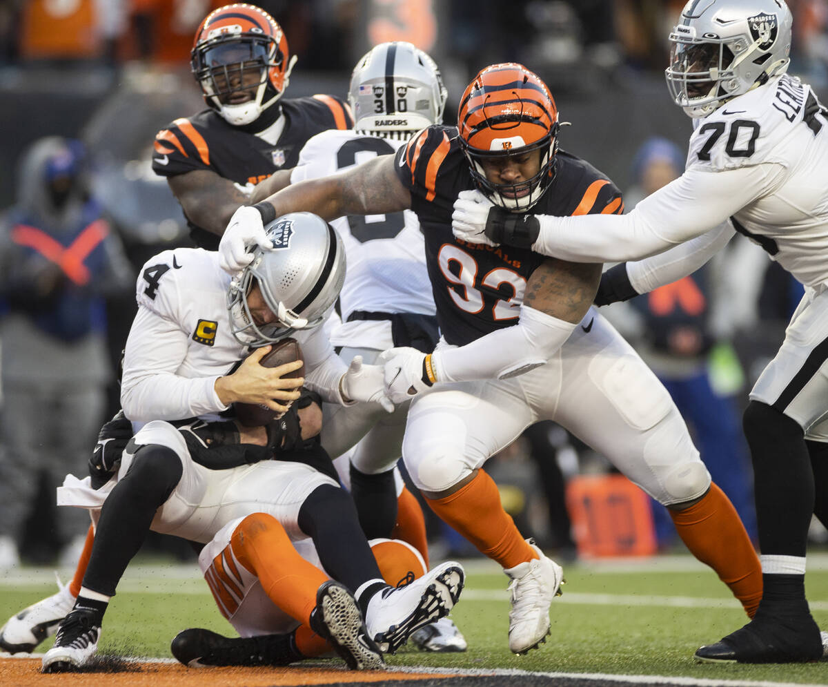 Raiders quarterback Derek Carr (4) is sacked at the goal line by Cincinnati Bengals defensive e ...
