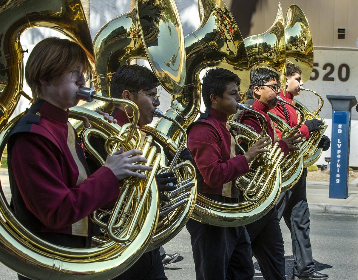 Members of the Dragon Fire Band from the Del Sol Academy of Performing Arts march and play for ...