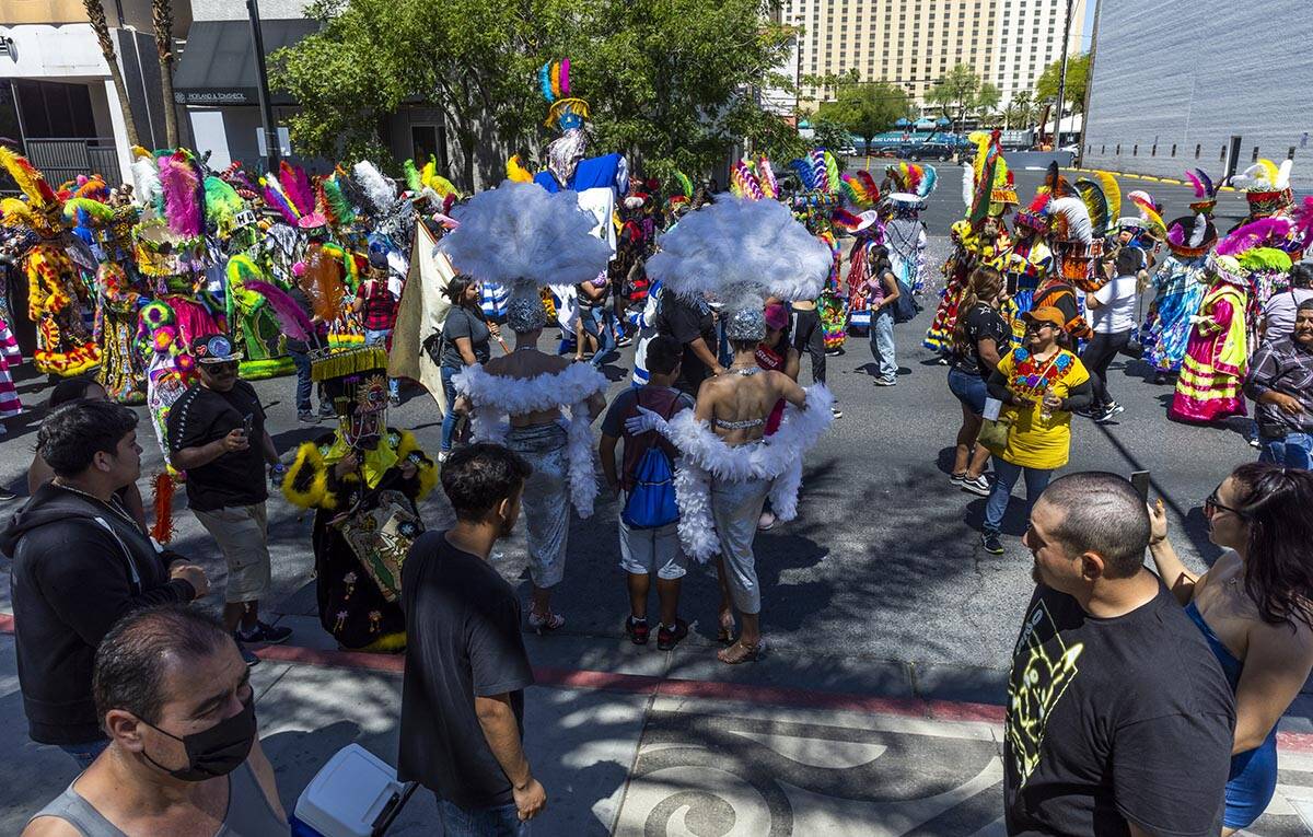 Fourth Street is crowded with attendees as members of Comparsa Fiesta Morelense perform during ...