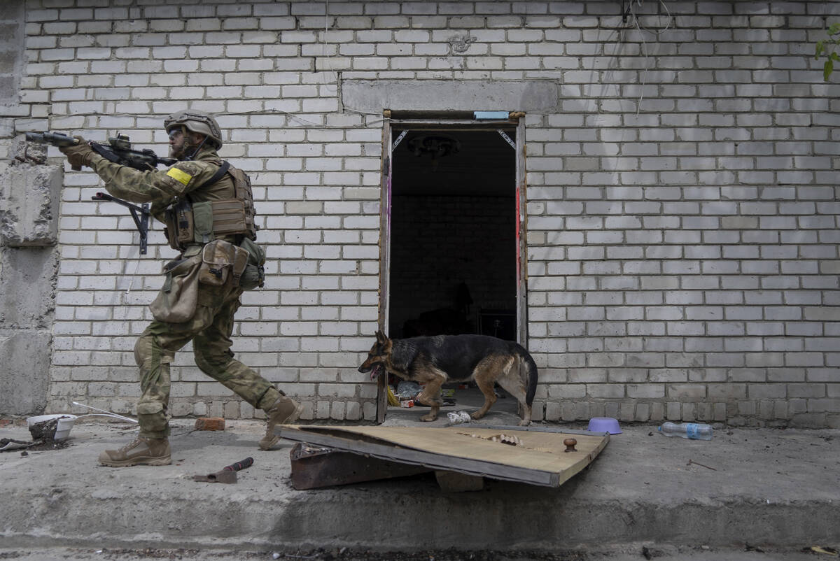 A Ukrainian serviceman patrols during a reconnaissance mission in a recently retaken village on ...