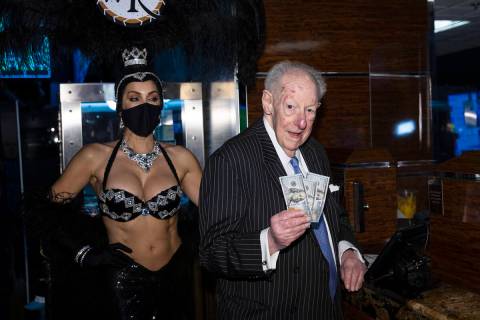 Former Las Vegas Mayor Oscar Goodman flashes dollar bills as he places his March Madness wager ...
