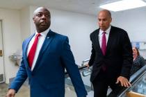 FILE - Sen. Tim Scott, R-S.C., left, and Sen. Cory Booker, D-N.J. talk as they walk from the Se ...