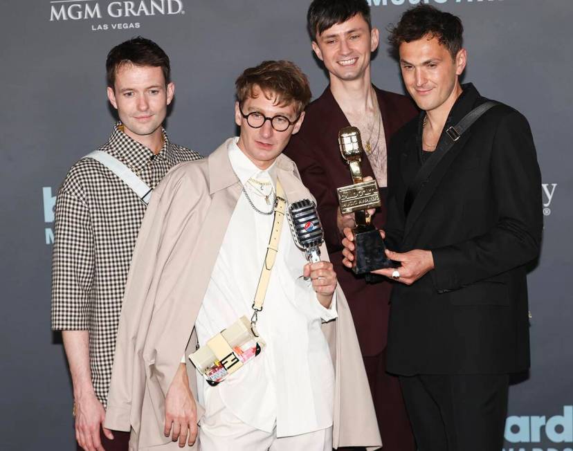 Members of Glass Animals pose with the "Top Rock Artist” award in the backstage press room du ...