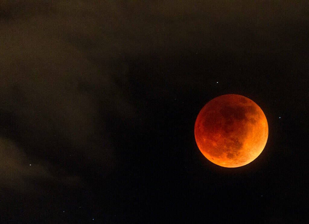 Clouds parted for a few moments to reveal the full lunar eclipse of the Super Flower Blood Moon ...