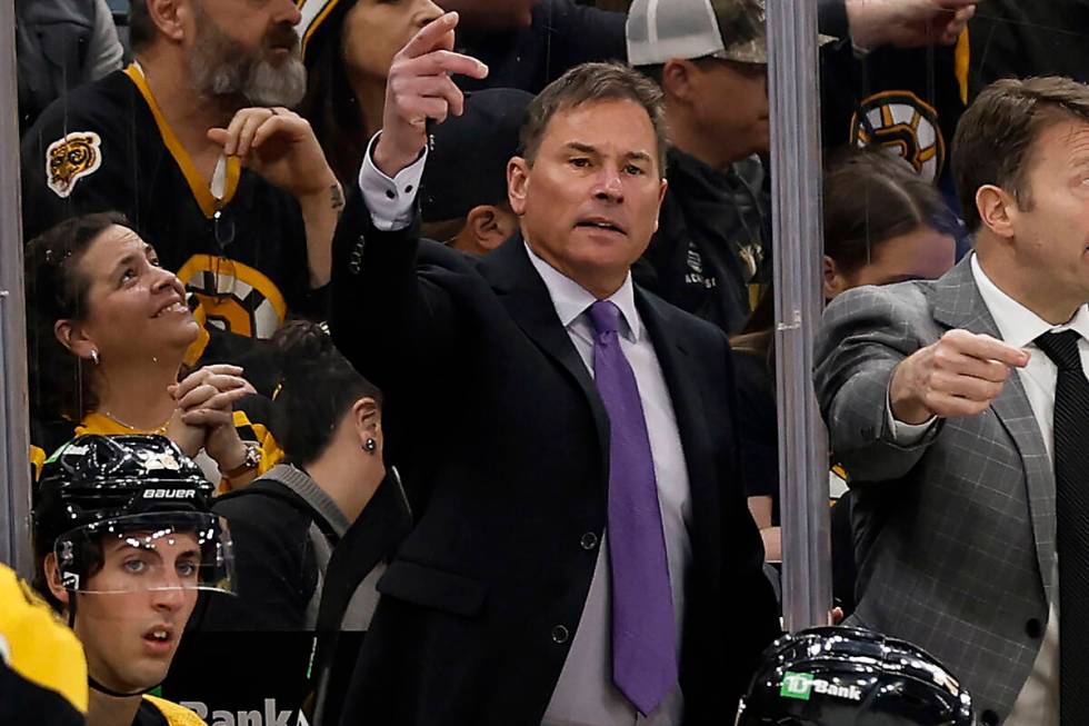 FILE -Boston Bruins head coach Bruce Cassidy, center, gestures during the third period of an NH ...