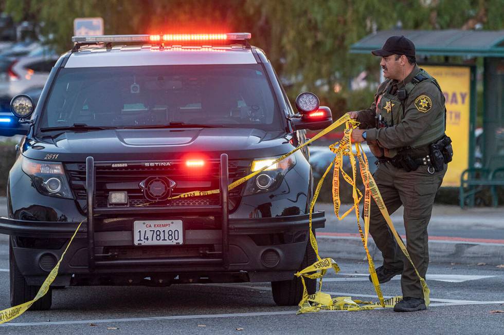 A Orange County Sheriff deputy removes yellow tape from a vehicle outside the Geneva Presbyteri ...