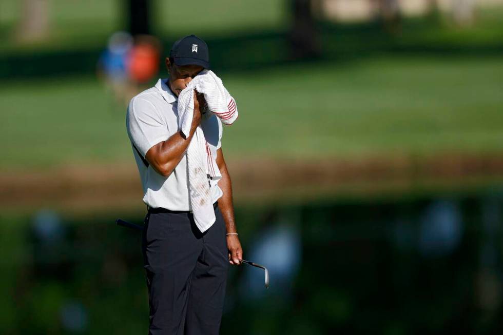 Tiger Woods wipes his face on the 11th green during a practice round for the PGA Championship g ...