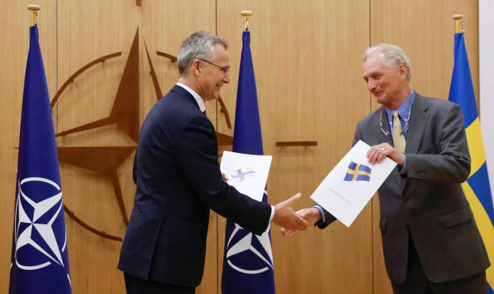 NATO Secretary-General Jens Stoltenberg and Sweden's Ambassador to NATO Axel Wernhoff shake han ...