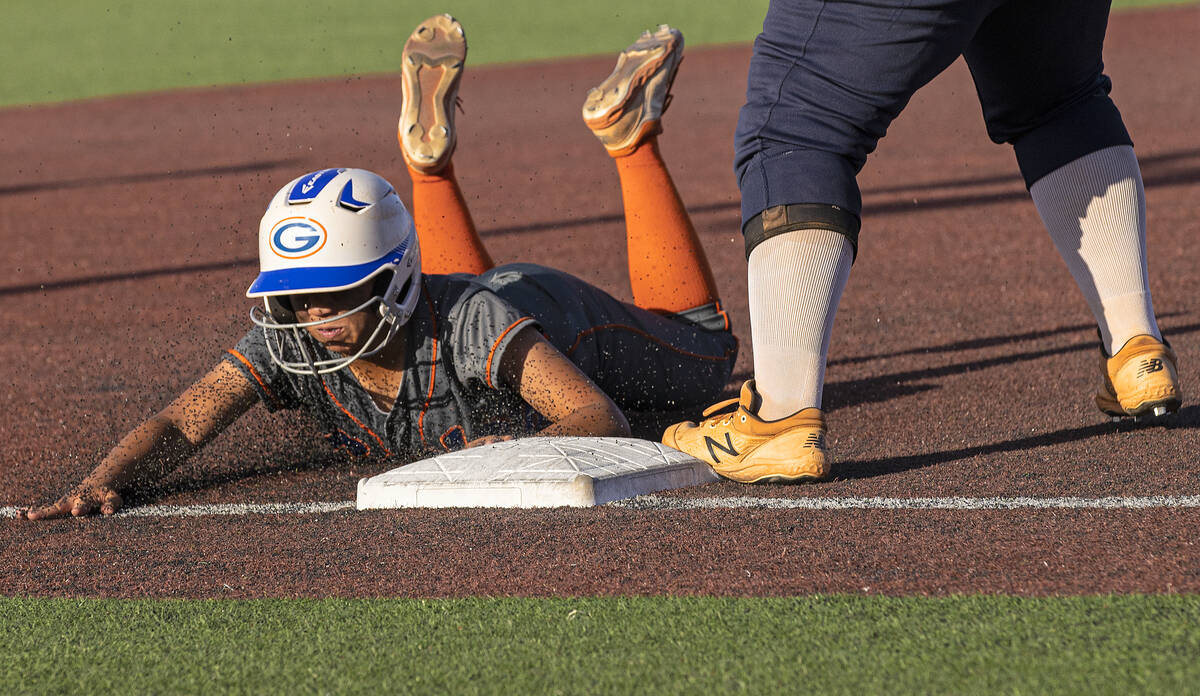Bishop Gorman’s Kayla Acres (16) slides into third base during a Class 4A state softball ...