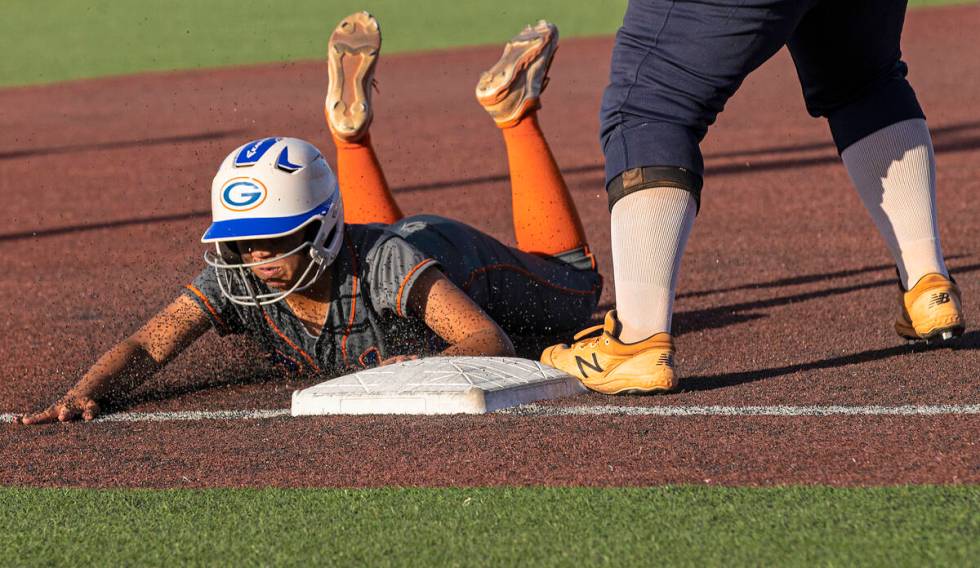 Bishop Gorman’s Kayla Acres (16) slides into third base during a Class 4A state softball ...